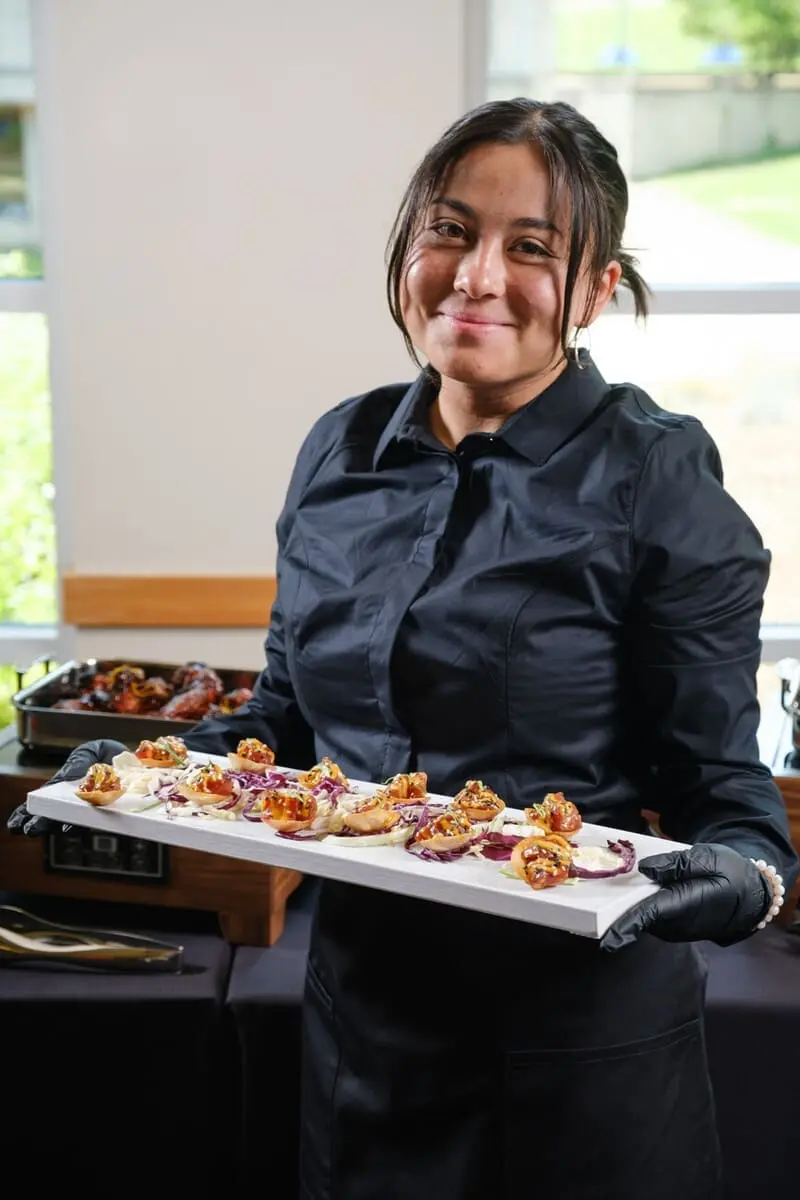 Server holding a plate of hors d'oeuvres